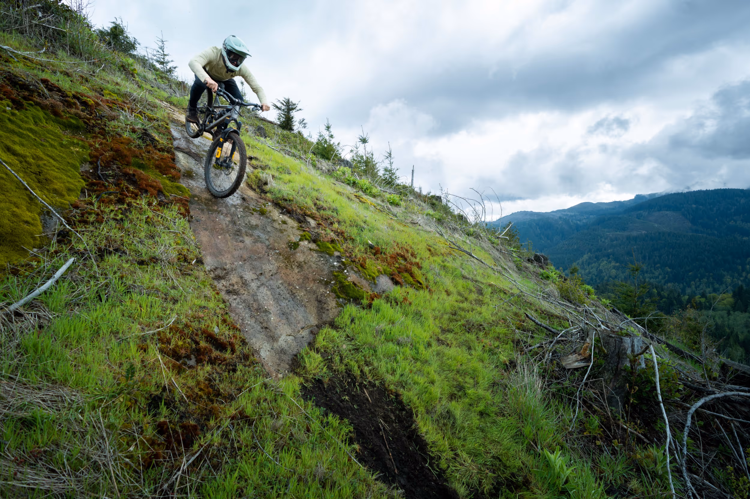 A mountain biker navigating down a steep trail