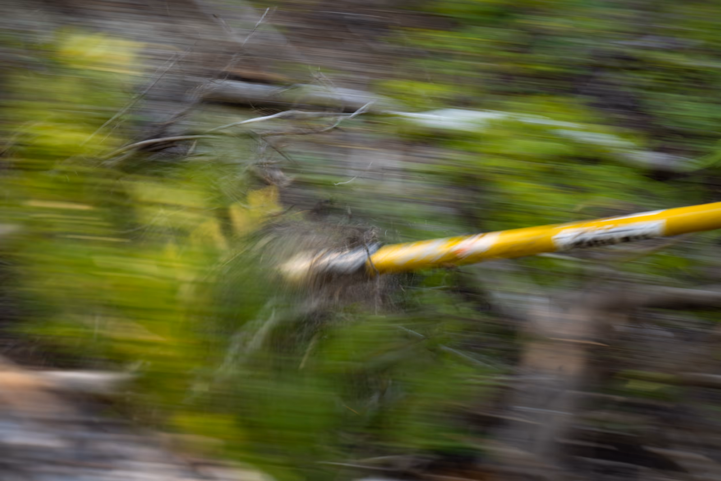 A blurred action shot of a McLeod trail tool digging into a mountain bike trail 
