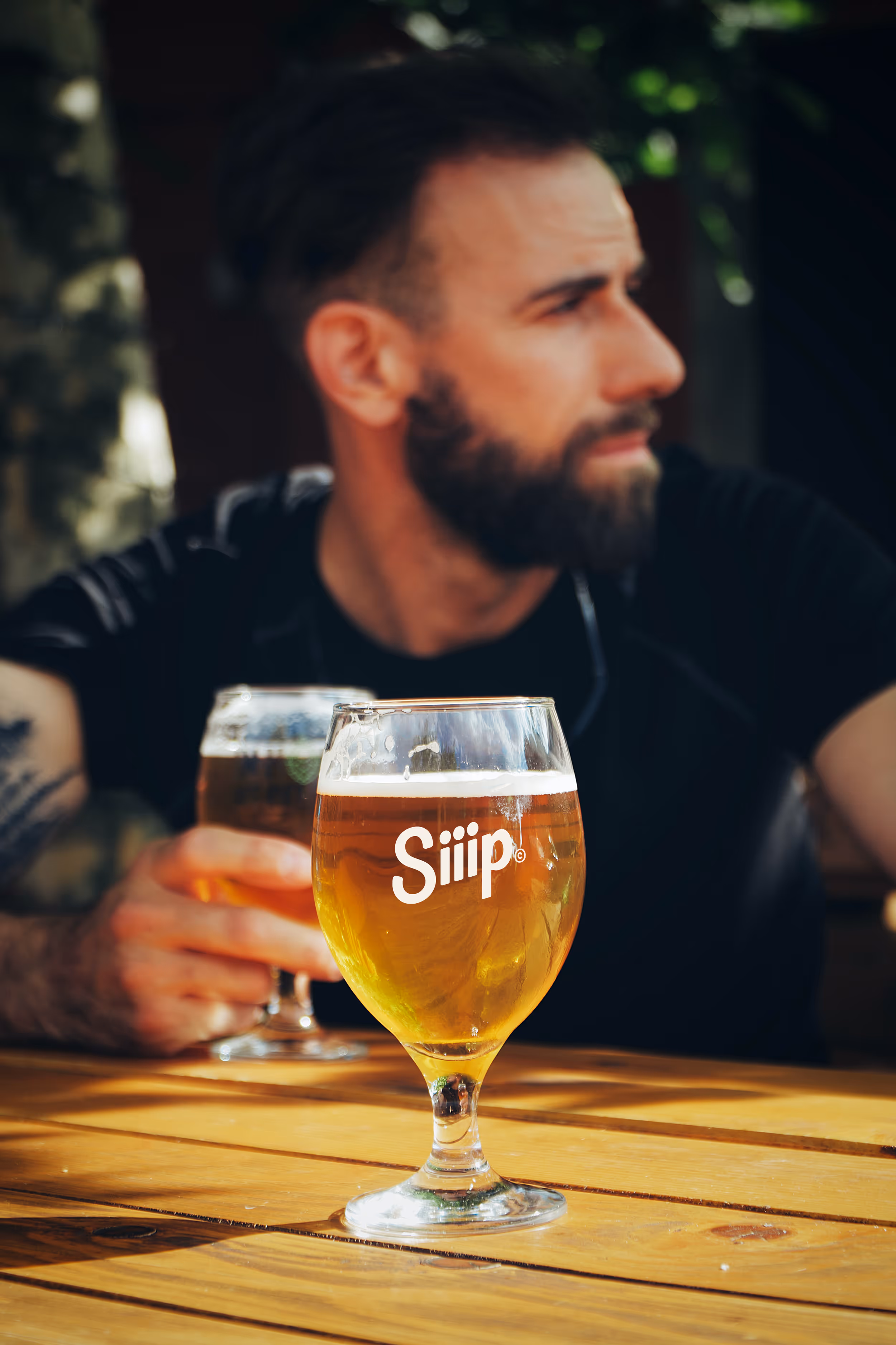 A man drinking a beer with Siiip on their beer glass