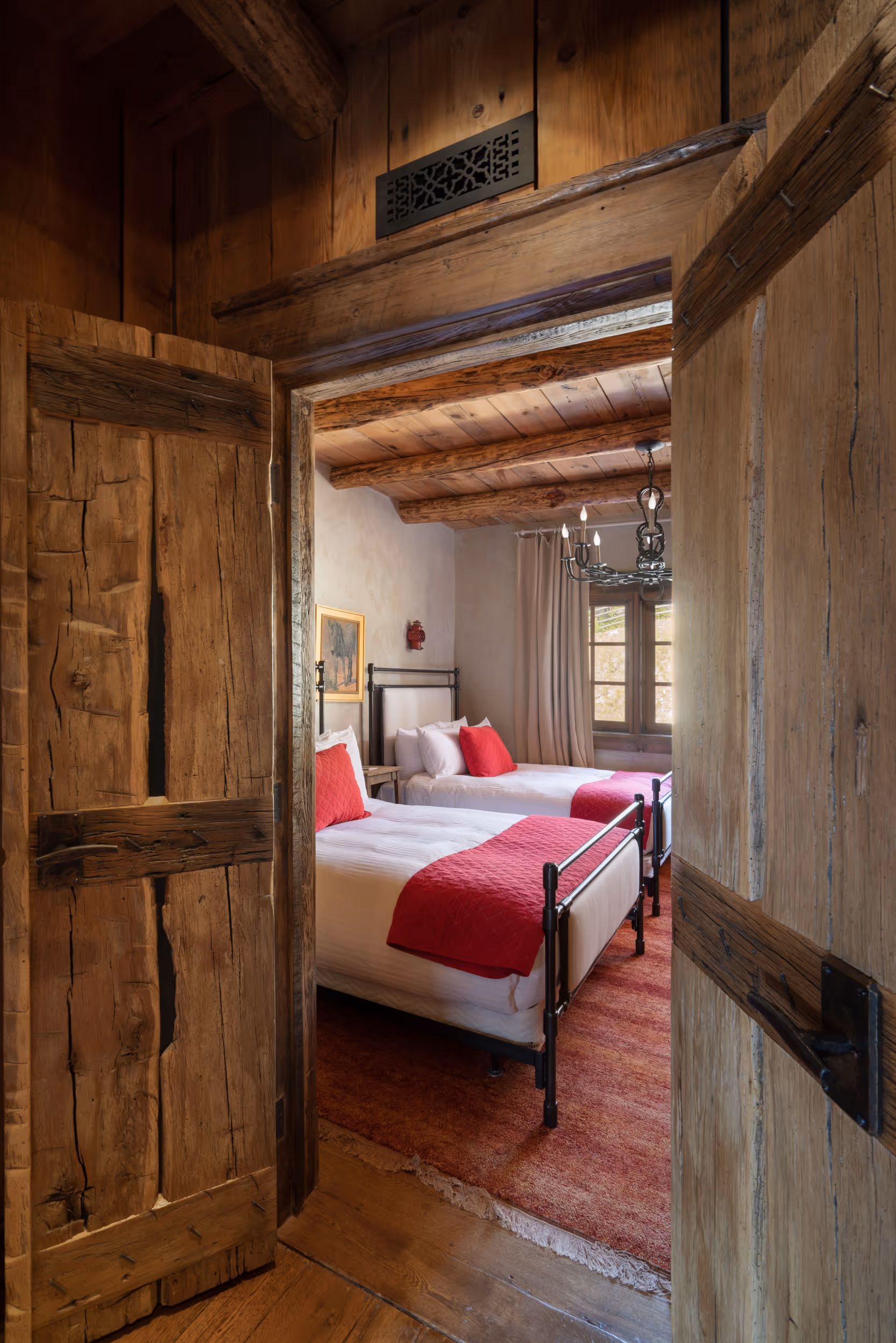 A peek into a guest bedroom with 2 queen beds 