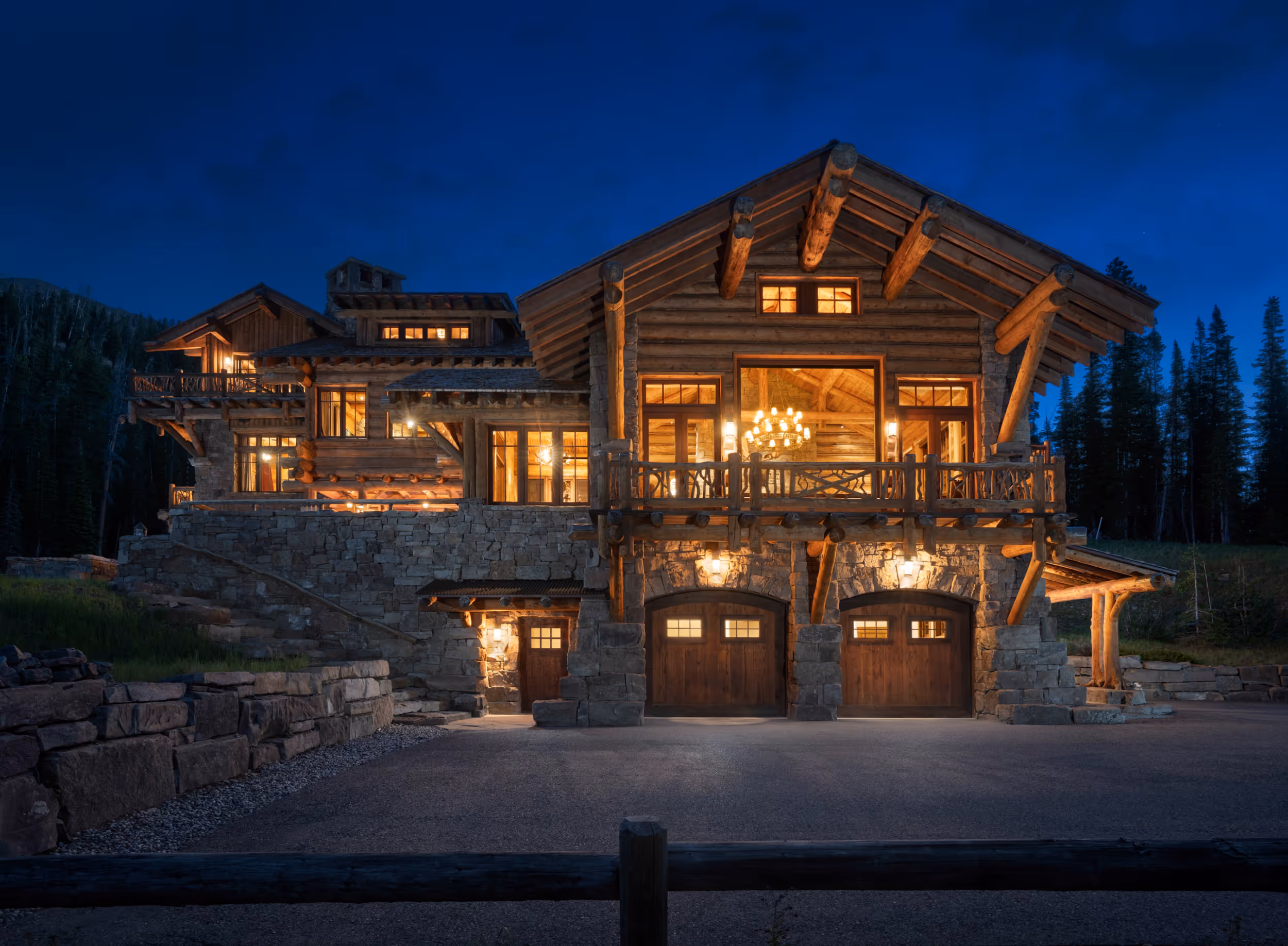 A well-lit luxurious stone/wooden cabin with large windows 