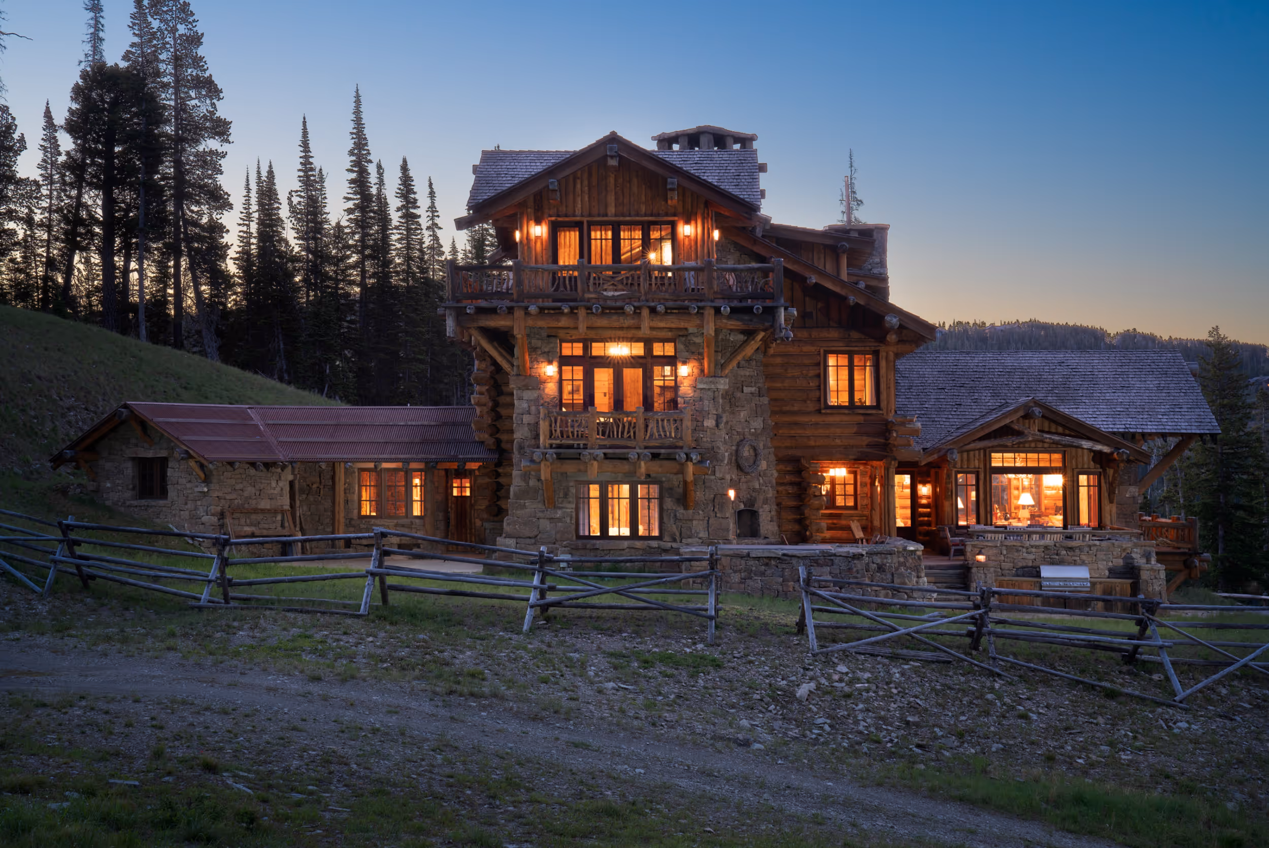 A well lit luxurious mountain getaway with wood and stone exteriors 