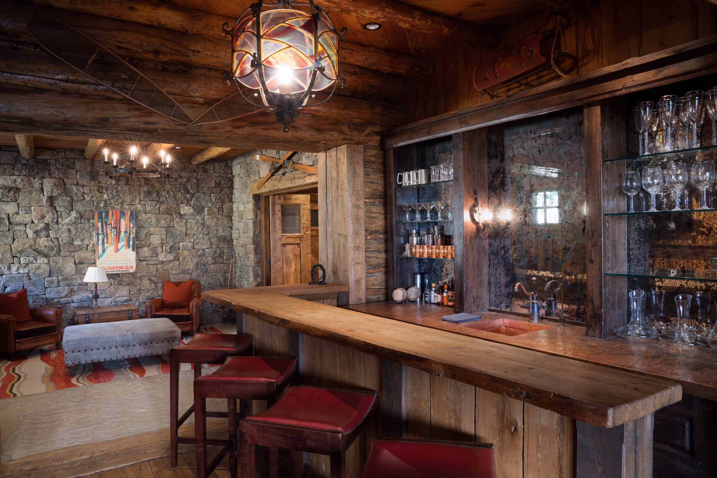 A view of the bar within a luxurious wooden cabin with a bar counter and bar stools 