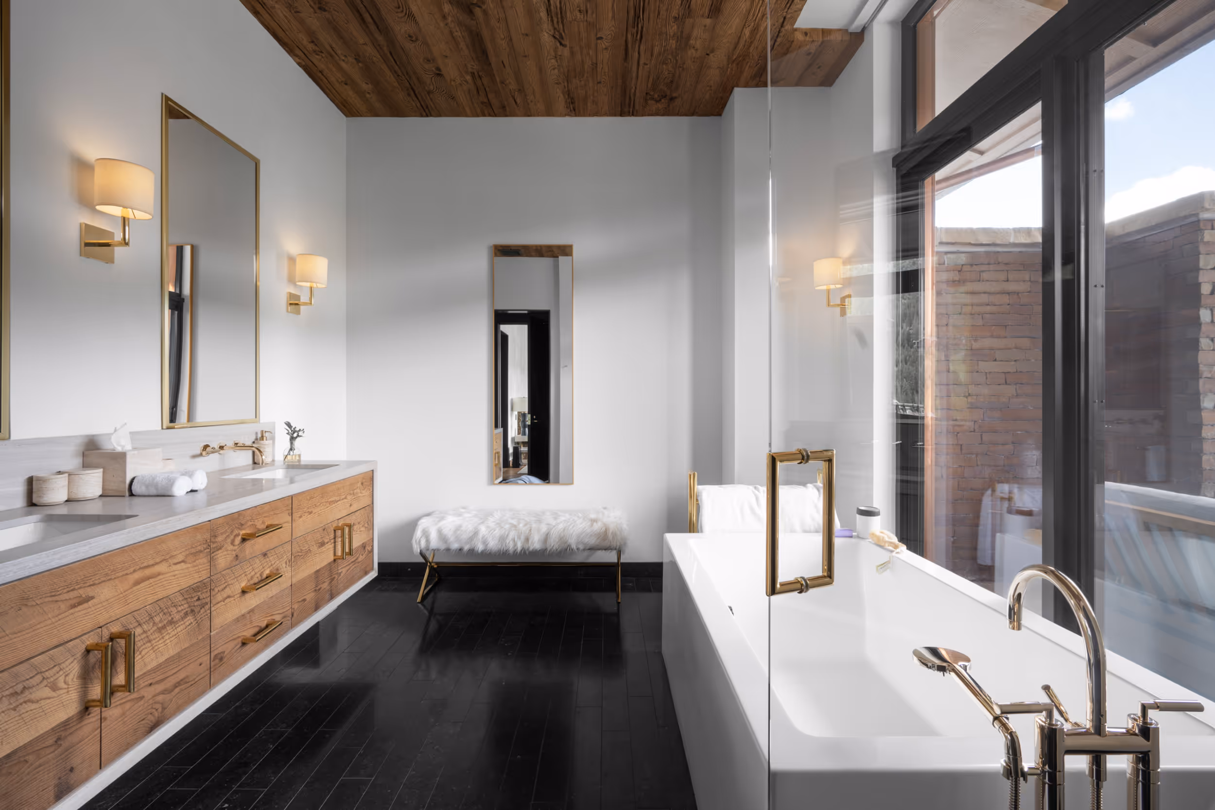 A large, luxurious bathroom with a bathtub next to the window