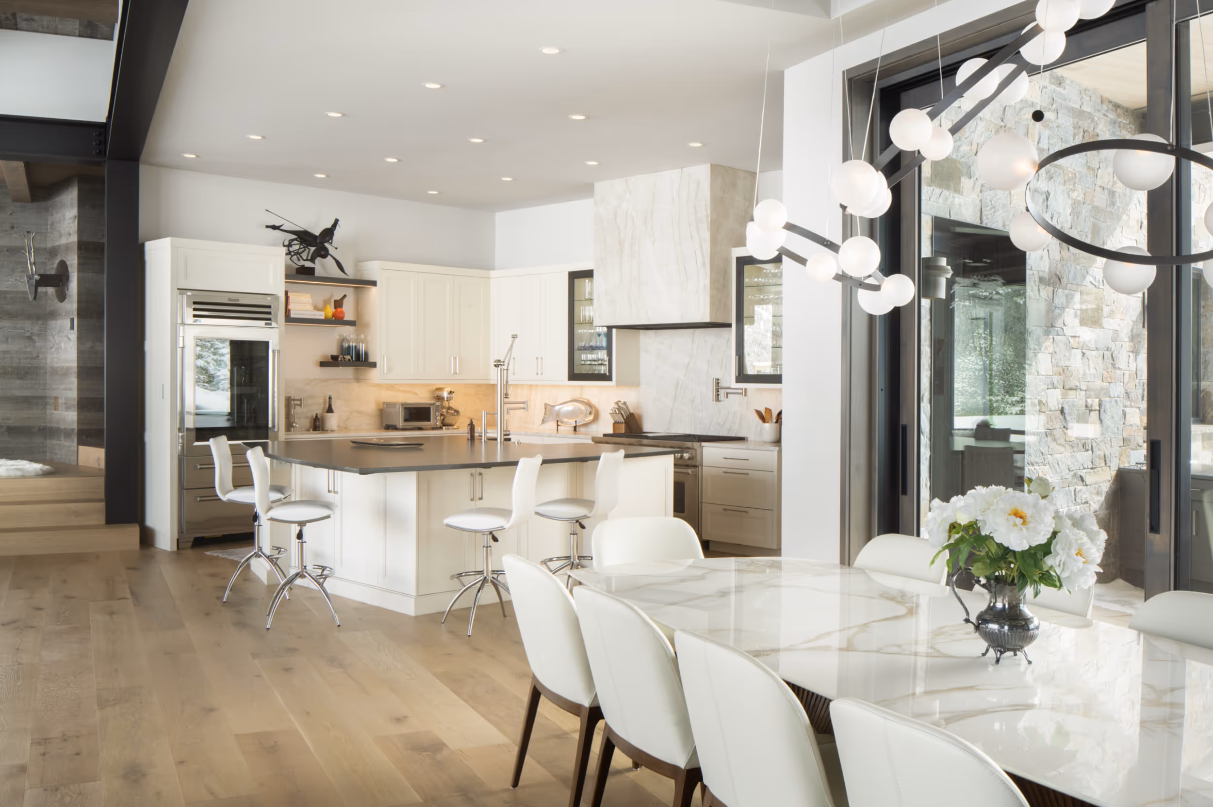 A bright, luxurious kitchen with a white marble dining table
