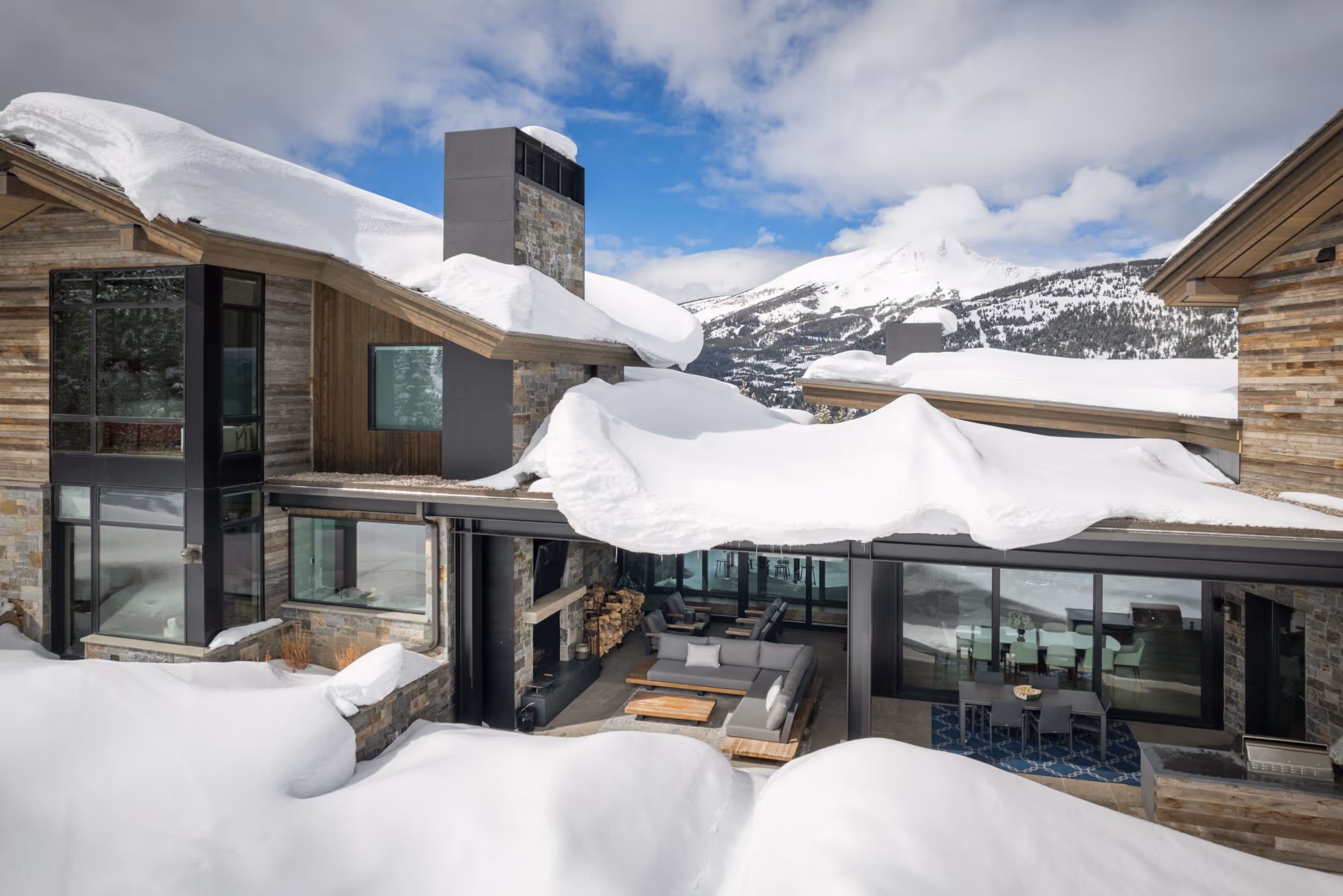 The outside of a luxurious, modern house covered in snow 