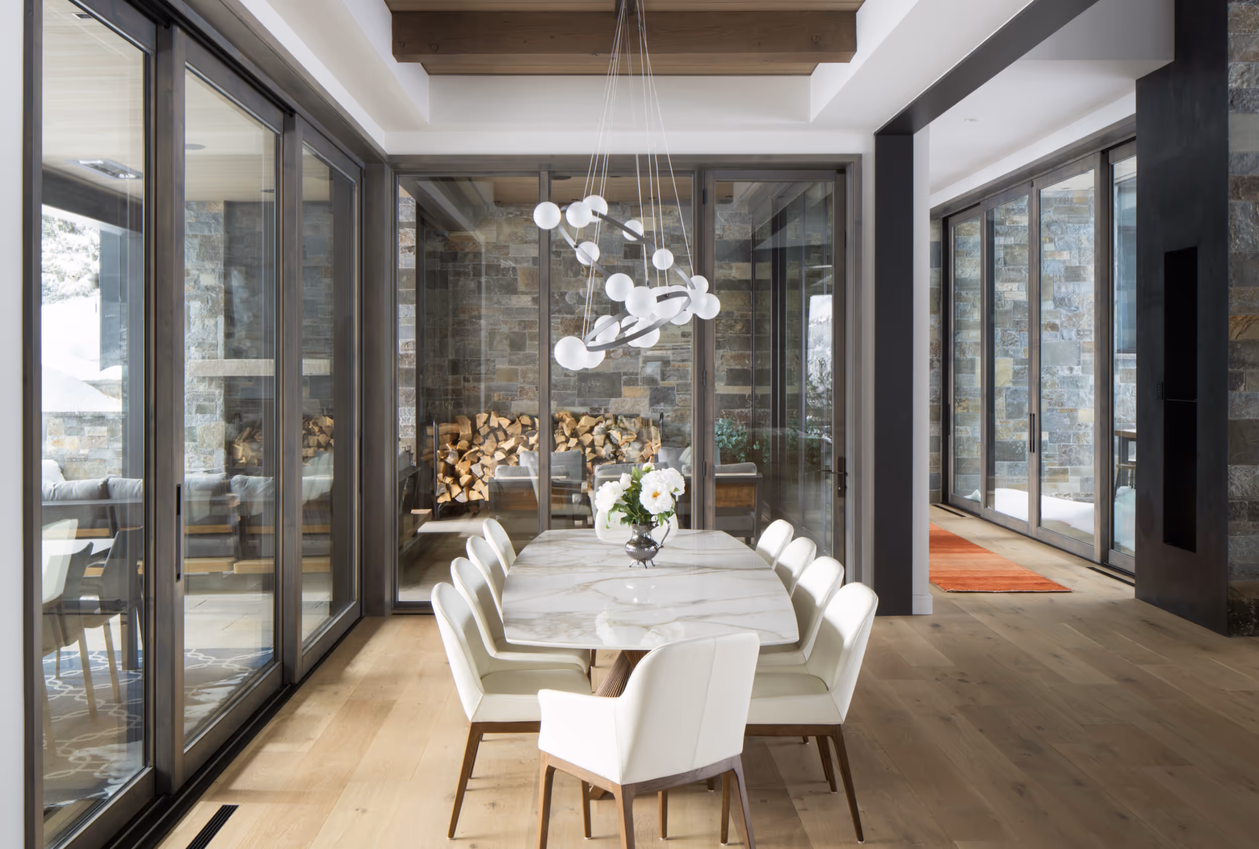 An elegant, modern dining area surrounded by windows 