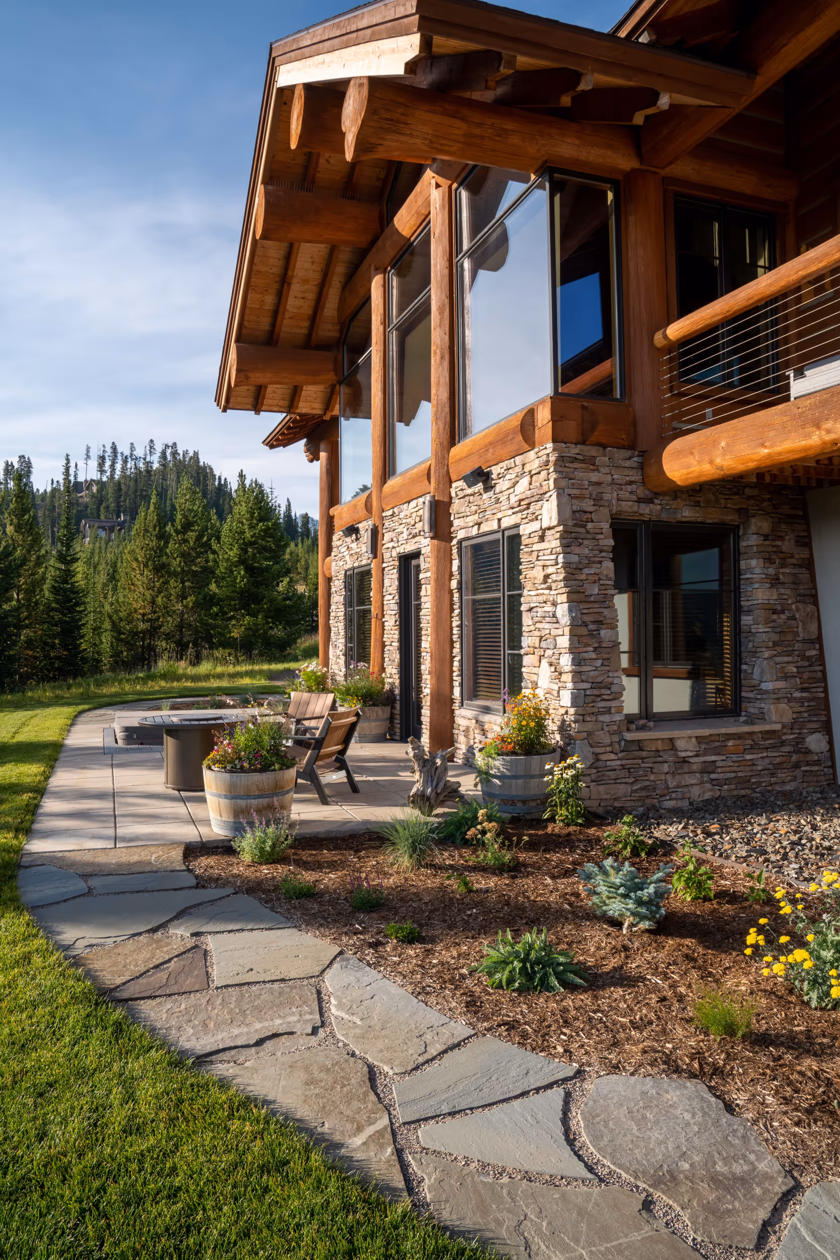 The front of a luxurious stone and log cabin home 