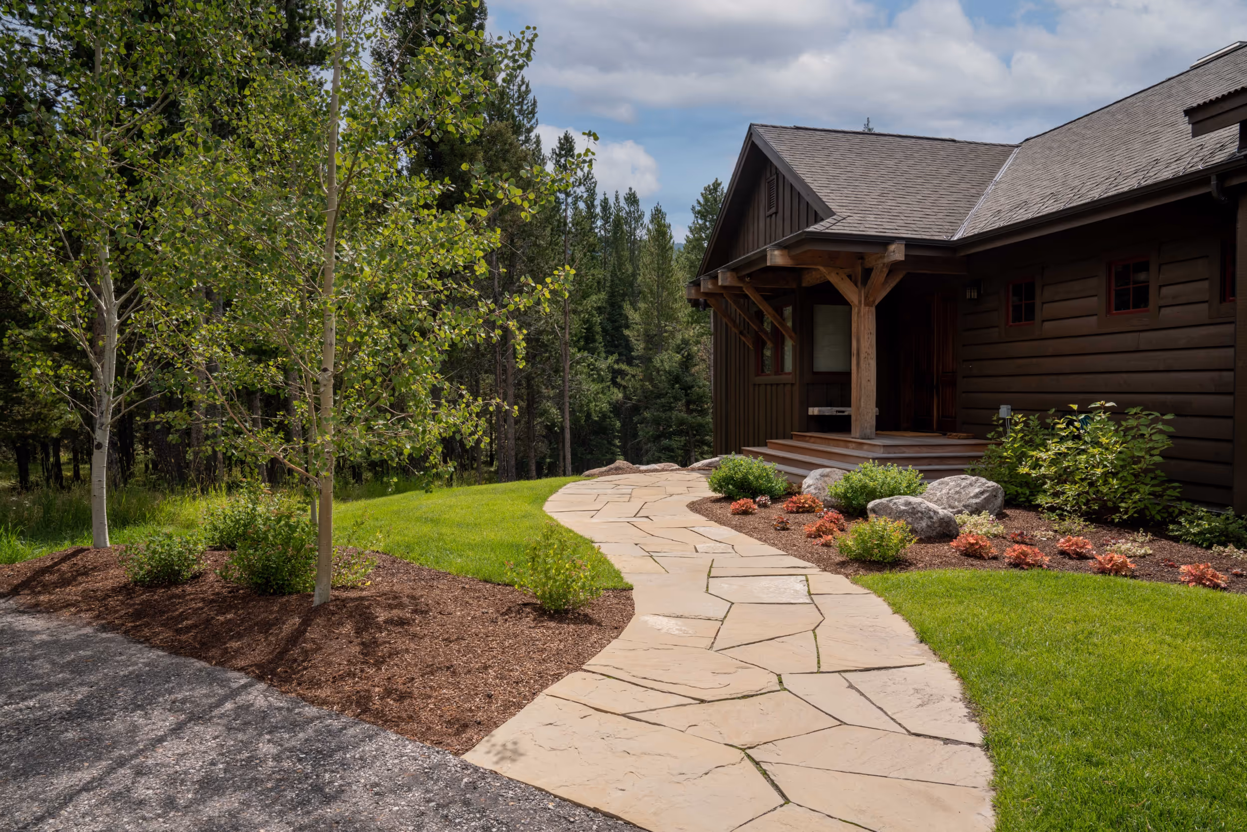 A stone path leading to the front of a house 