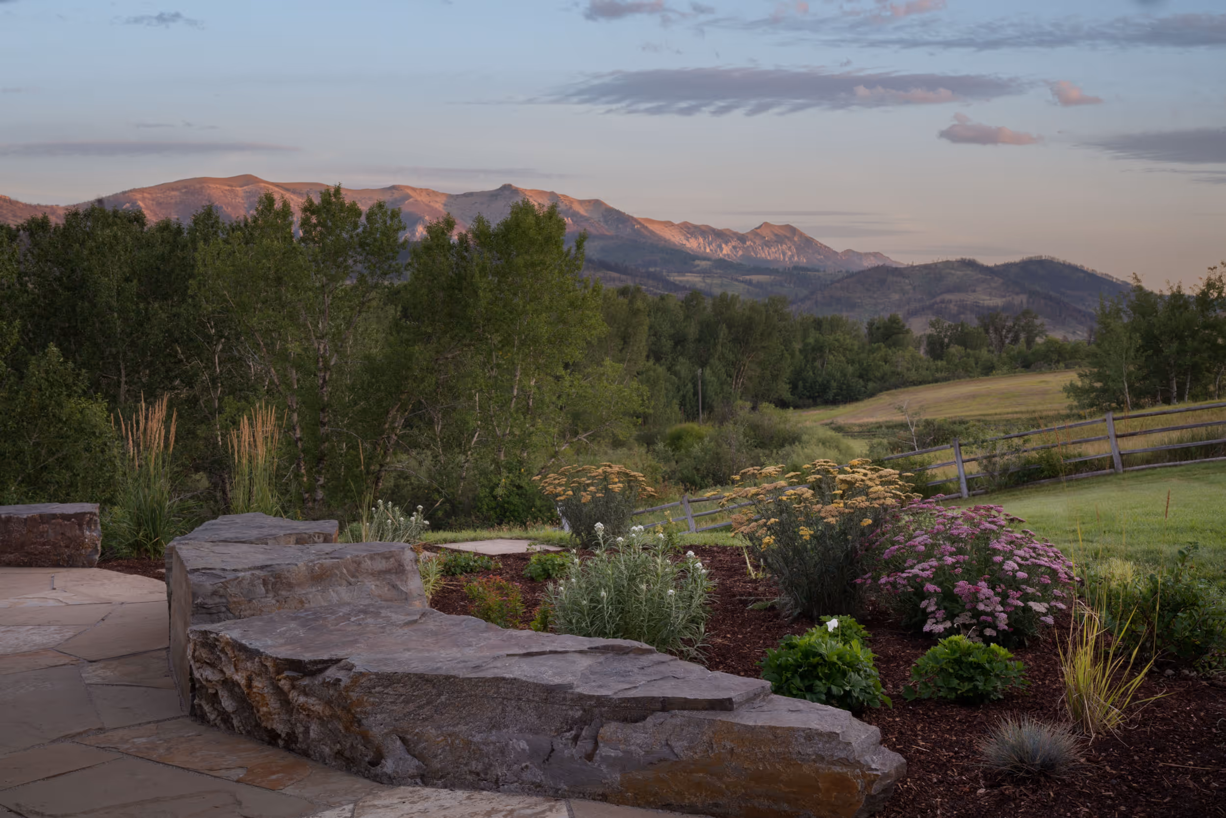 A well manicured garden overlooking the distant mountains