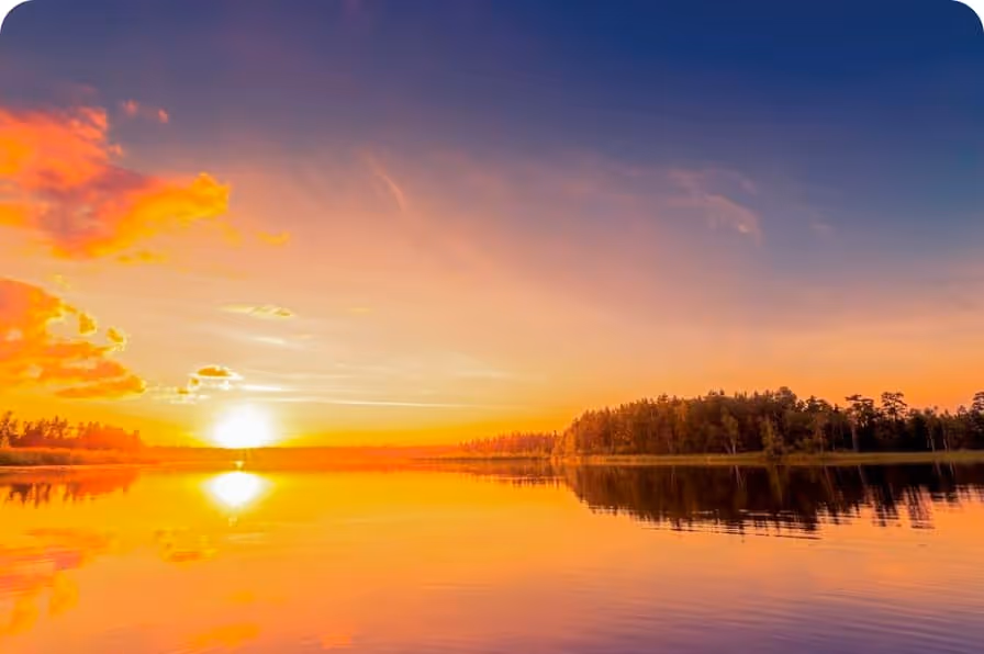 lake surrounded with trees at the time of sunset