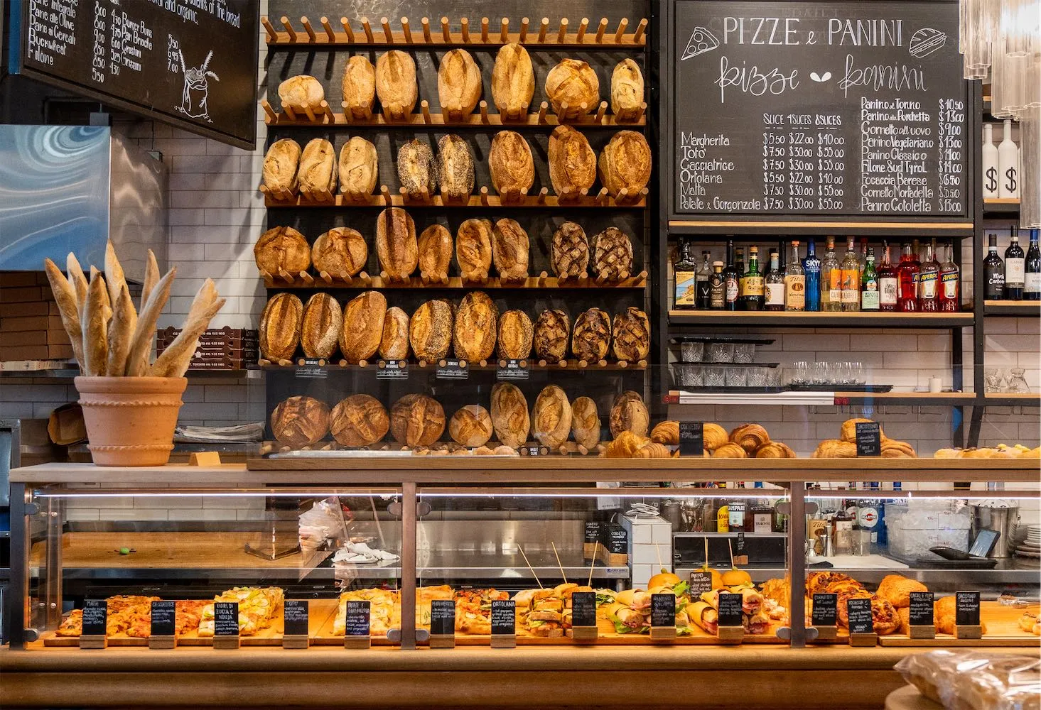 Exterior of Sud Forno Sackville with patio and Terroni Sud Forno Produzione e Spaccio signage in Toronto