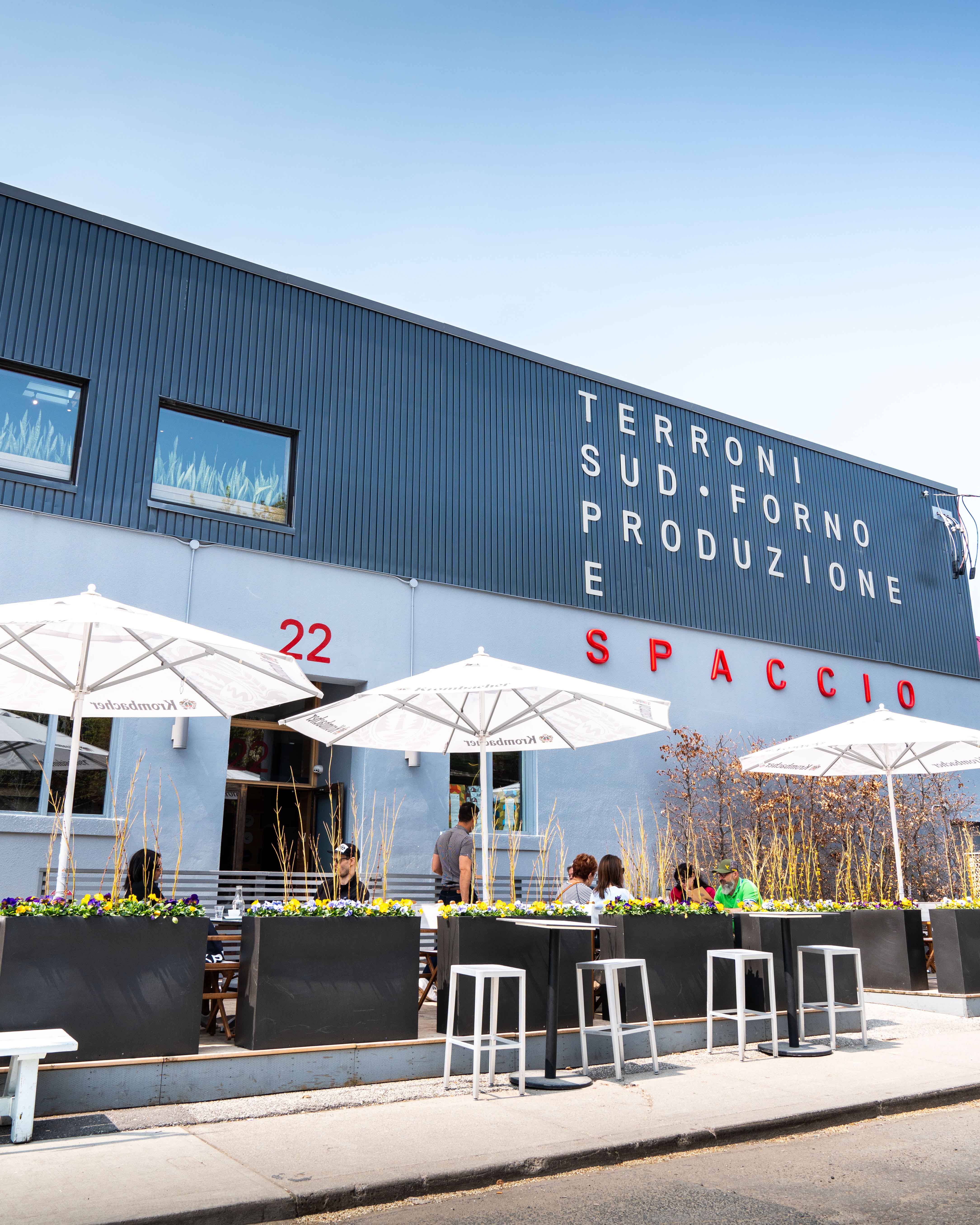 Exterior of the Terroni Sud Forno Produzione e Spaccio building with patio seating