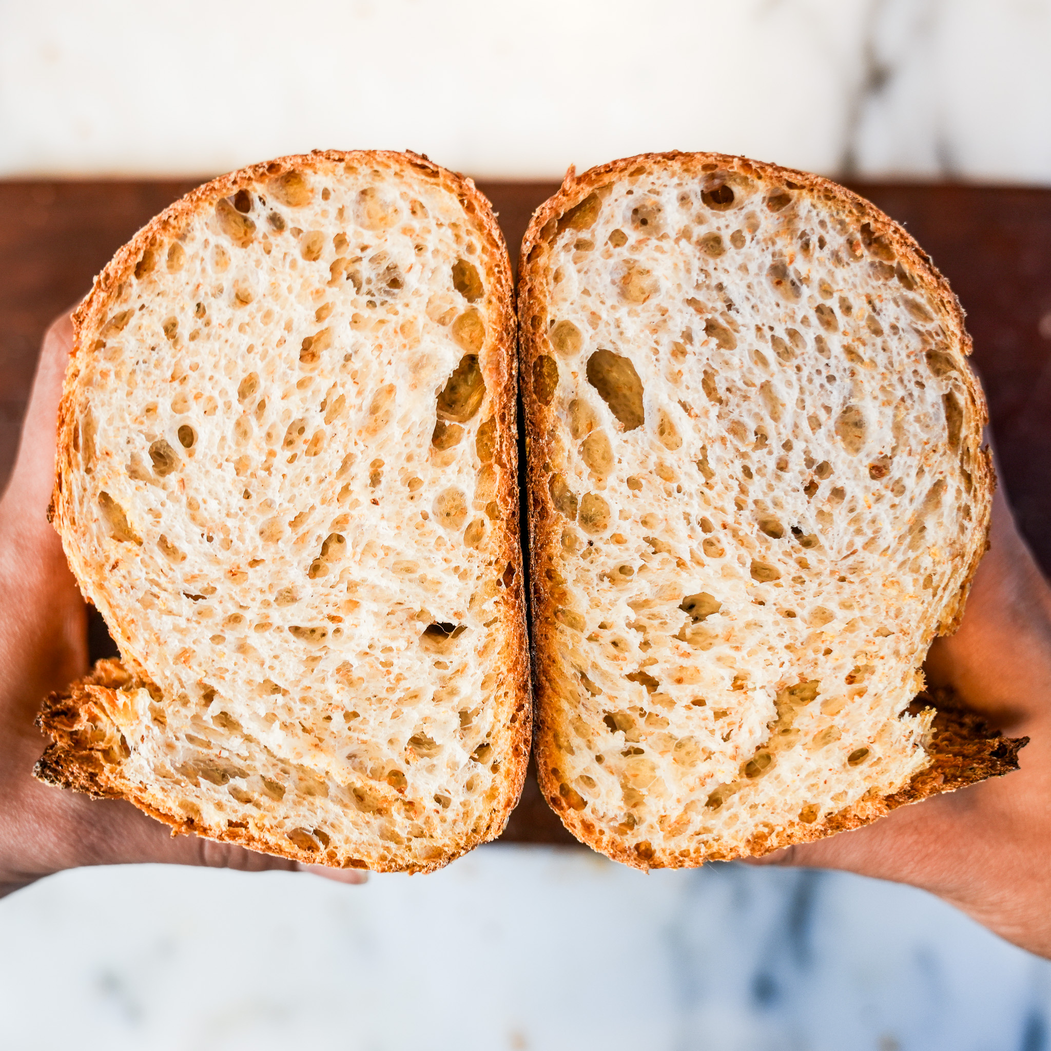Sliced sourdough loaf showing an open, airy crumb