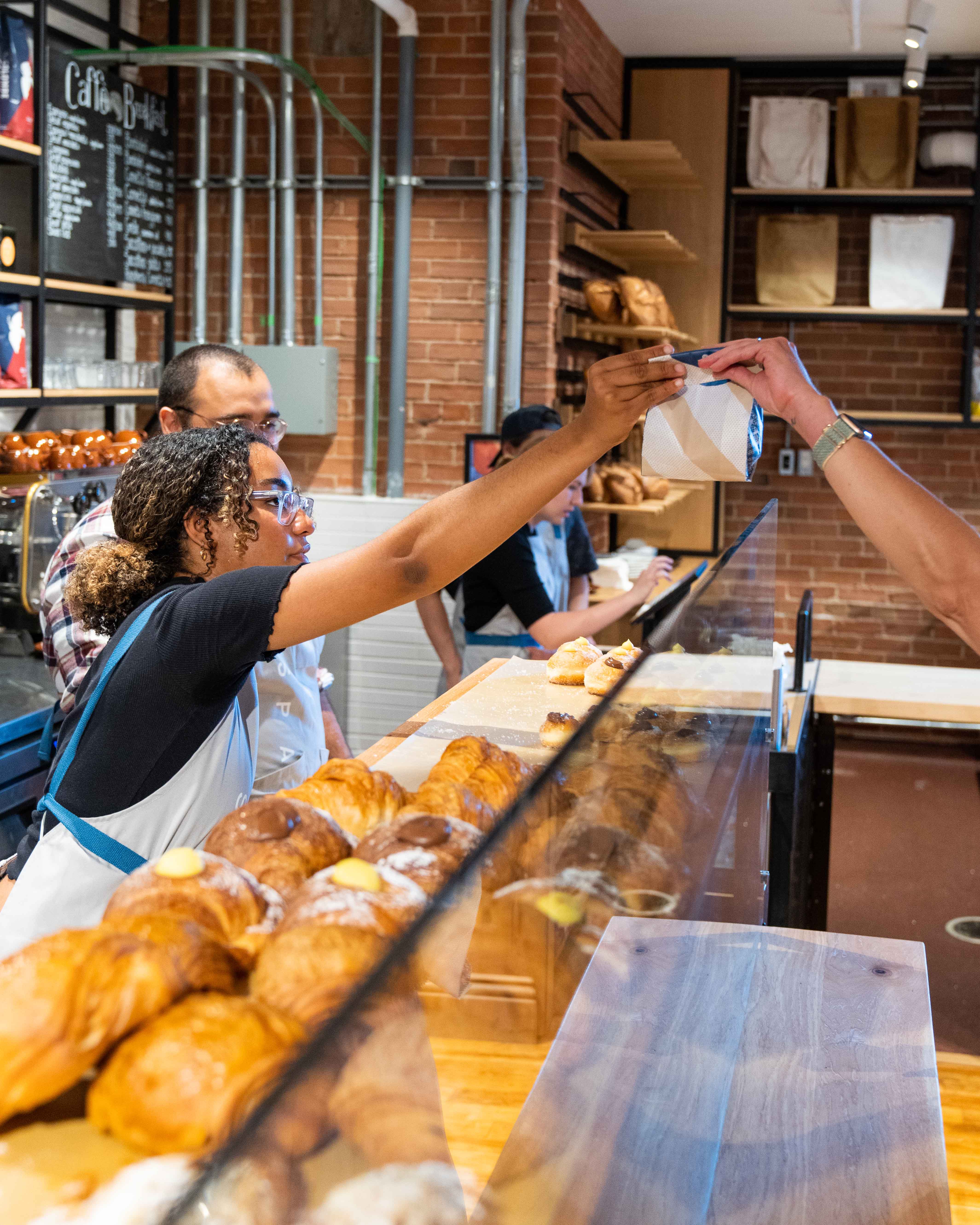 Bakery counter with fresh croissants and pastries in the display case
