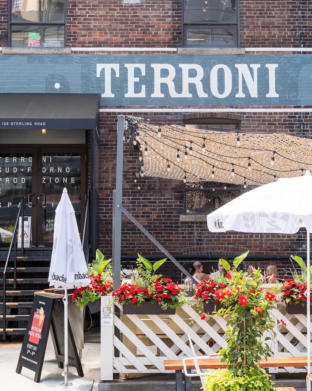 Storefront exterior with Terroni signage and patio string lights on Sterling Road, Toronto