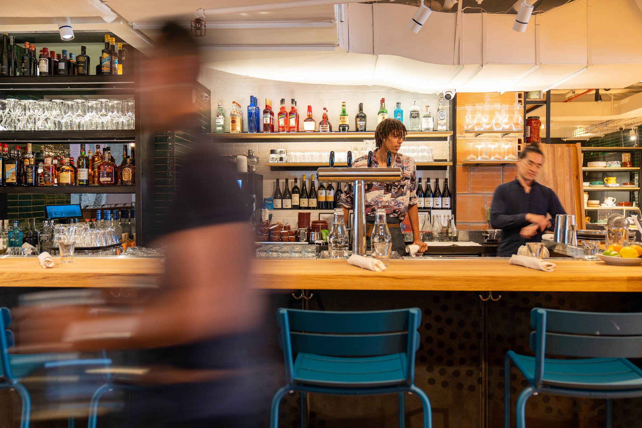 Bartender preparing drinks behind the bar at Terroni Sterling