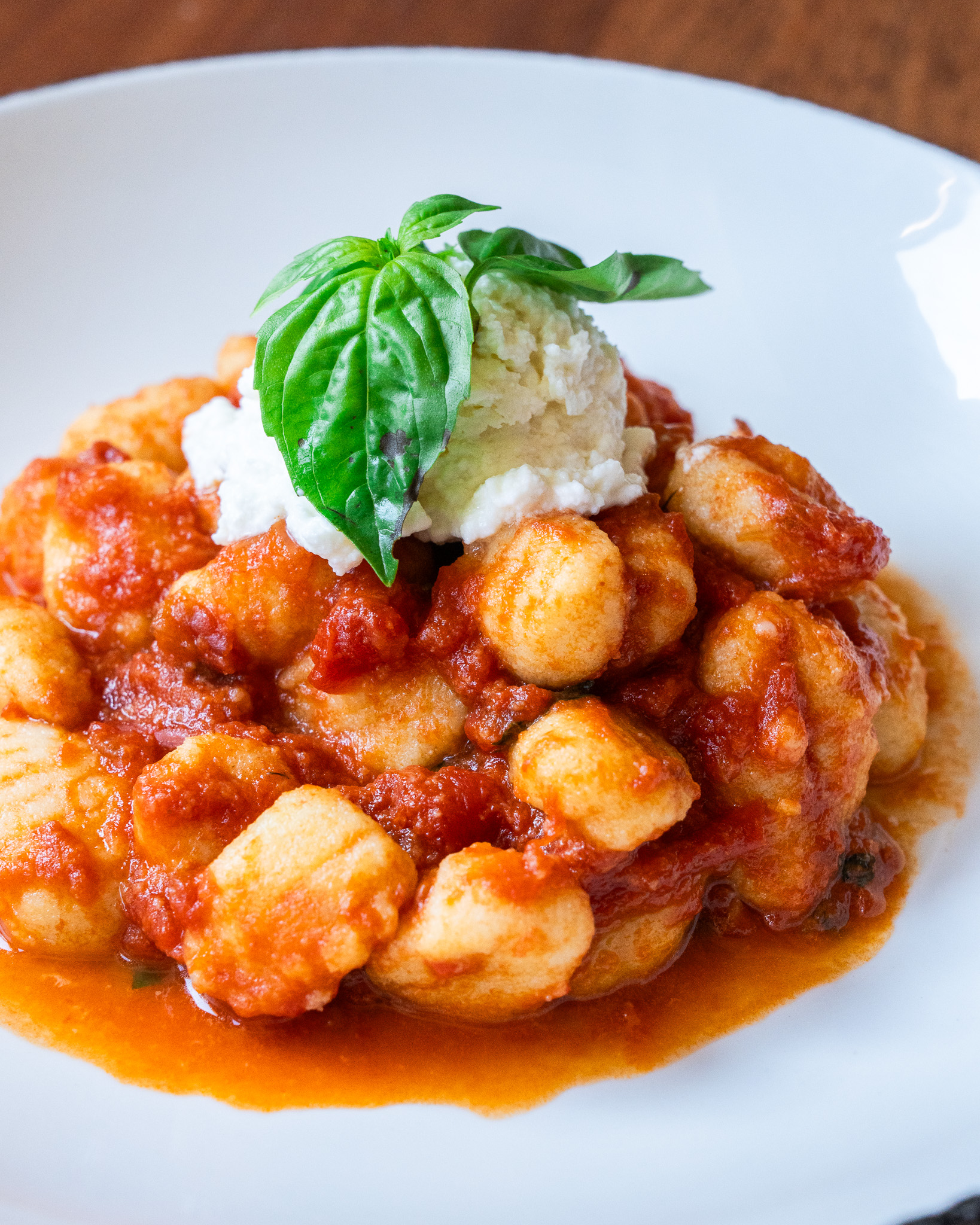 Gnocchi in tomato sauce topped with burrata and basil at Terroni Sterling