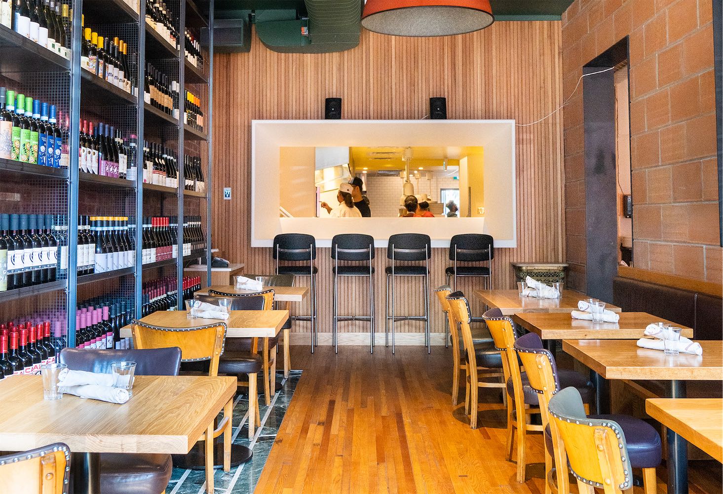 Chefs plating pasta in the open kitchen at Terroni Queen, Toronto's original Terroni location since 1992