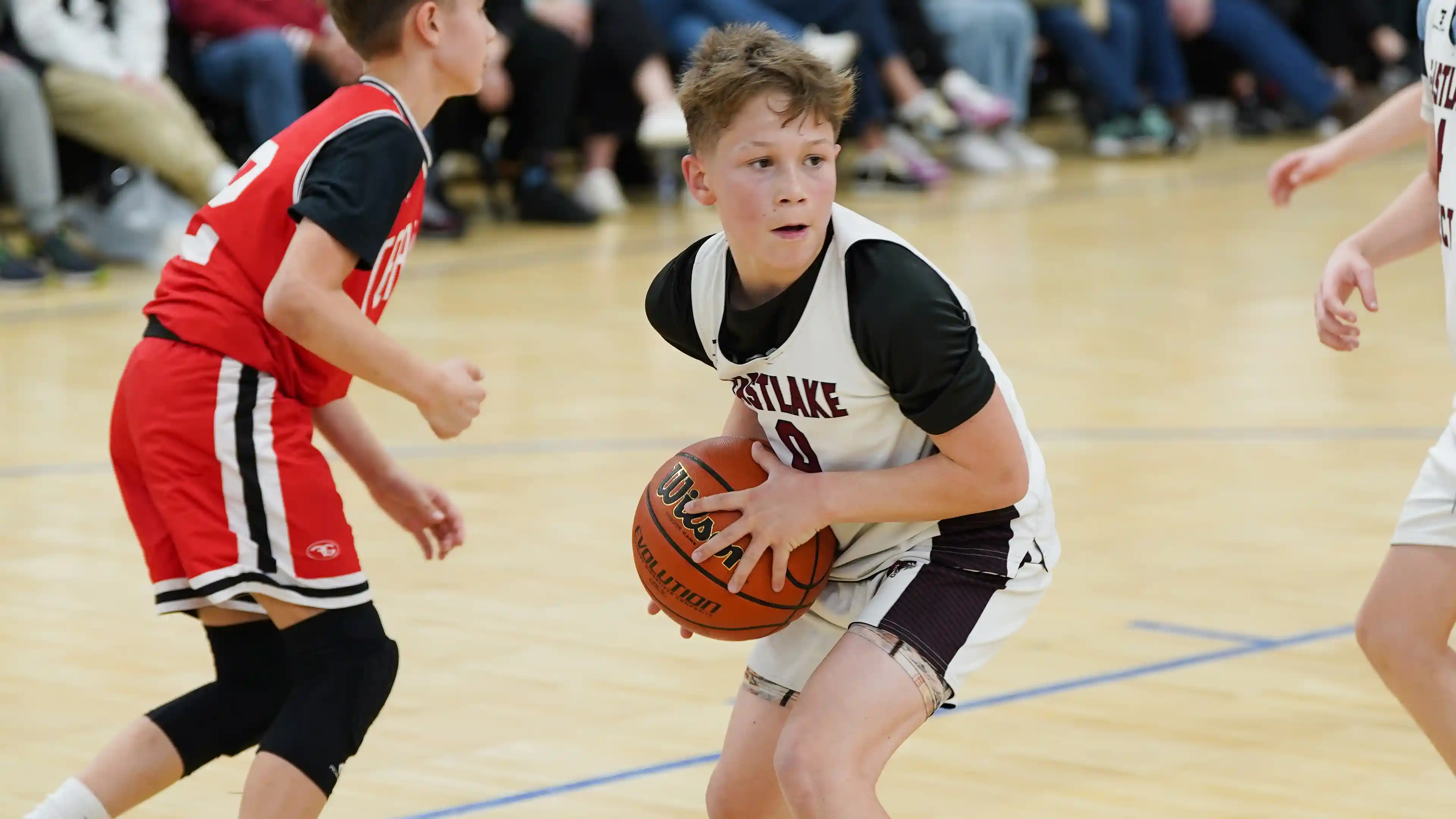 A basketball coach helping a player with their shooting form