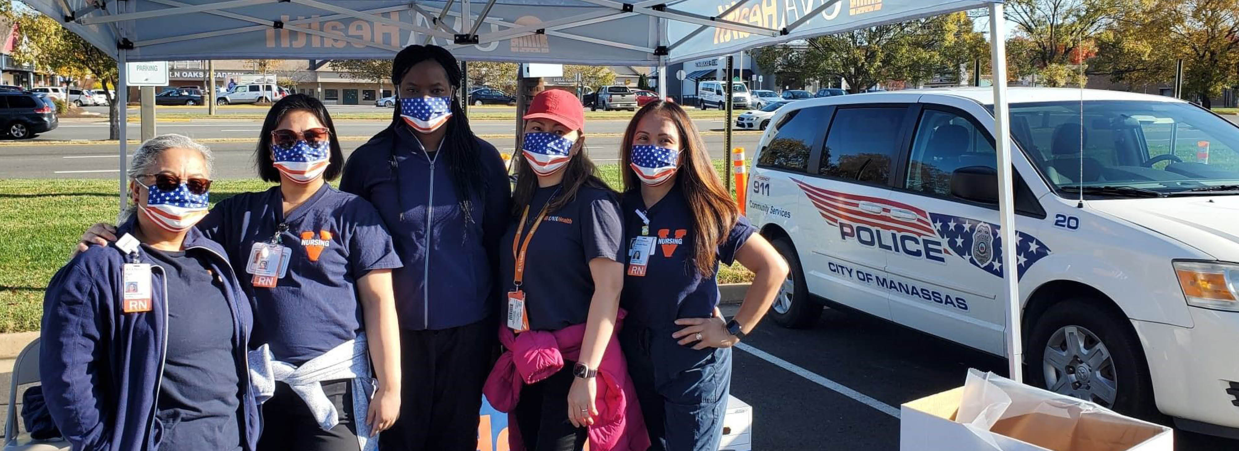 UVA Health team members standing under a tent outside