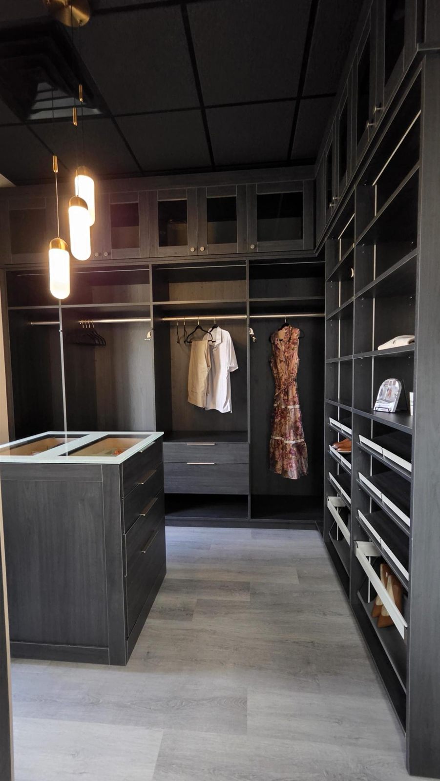 Dark wood walk-in closet display at the Perfection Custom Closets Edina showroom