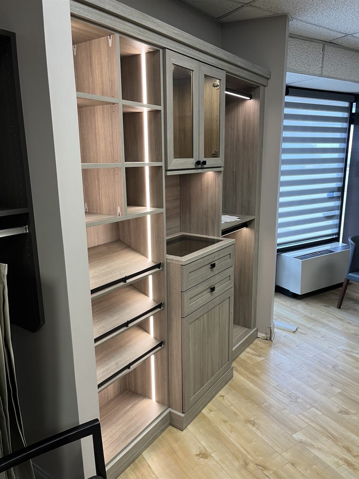 Lit closet display with glass doors at the Perfection Custom Closets Niles, IL showroom