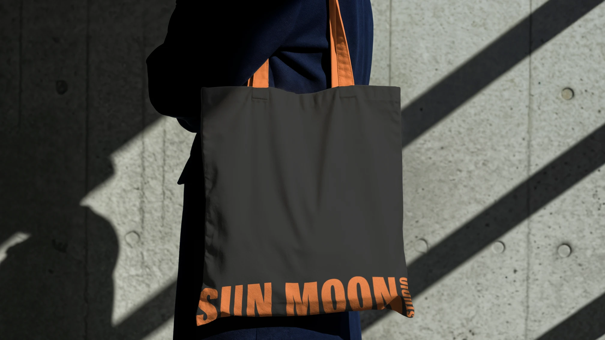 Sun Moon Studio branding applied to a black tote bag.