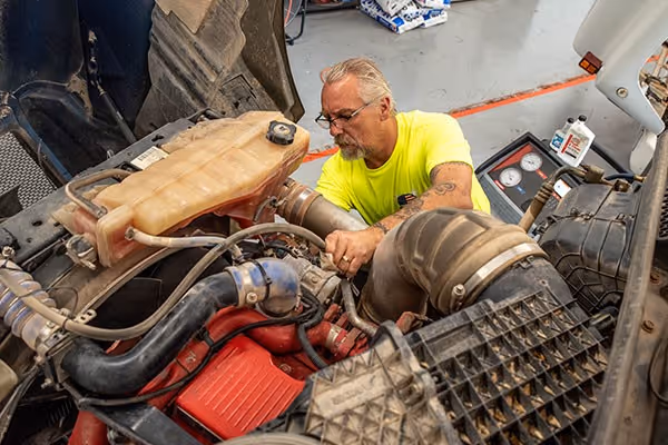 Integrity Fleet Services mechanic working on a fleet truck