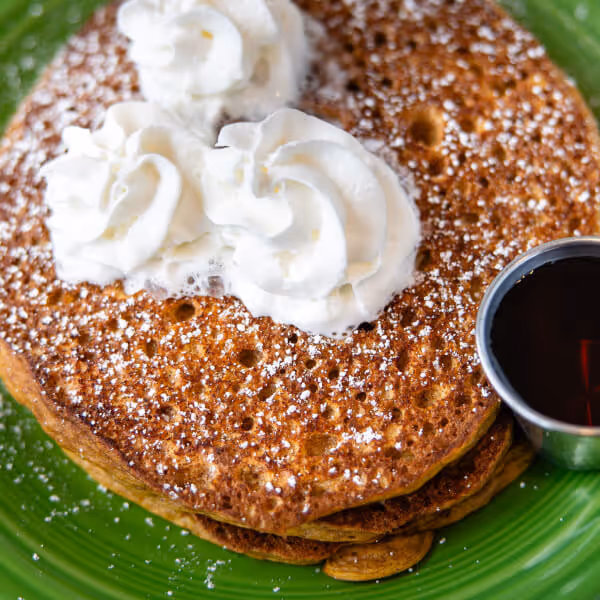 Three pumpkin cakes topped with powdered sugar and whipped cream. Served with pure NH maple syrup and a side of cinnamon maple butter.