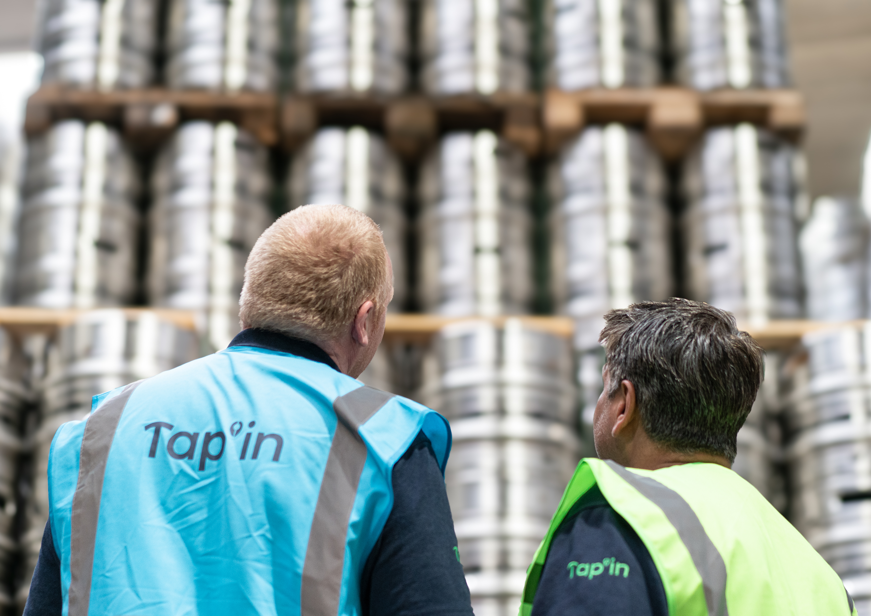 Tap'in 3PL staff with wall of kegs