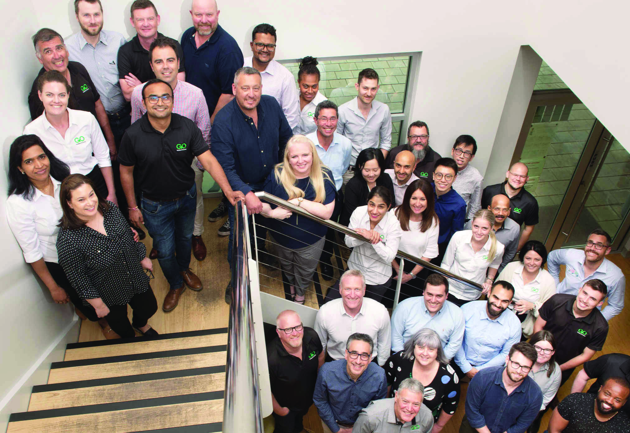 The Guidera O’Connor team gathered on a staircase
