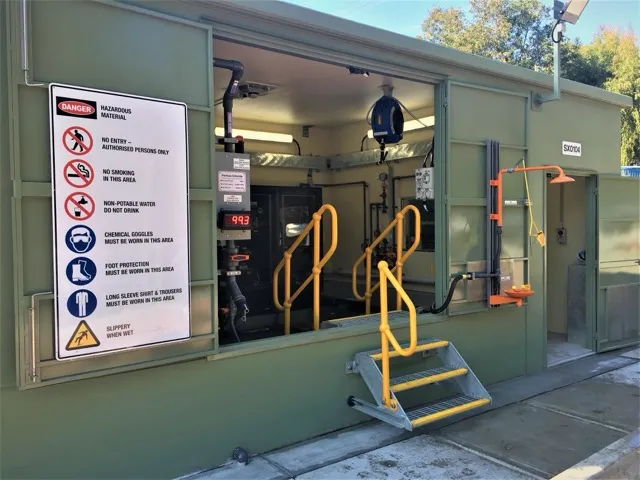 Chemical dosing facility with safety signage and access stairs