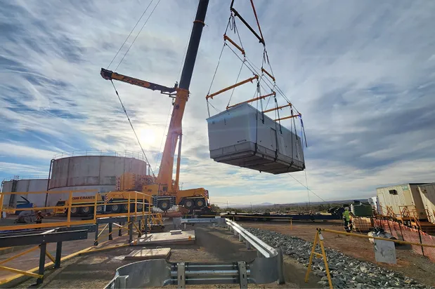 Crane lifting a dosing plant module into place at Newman