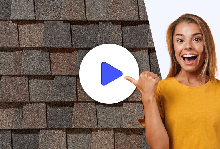 Happy homeowner standing in front of roofing shingles pointing towards a video play button