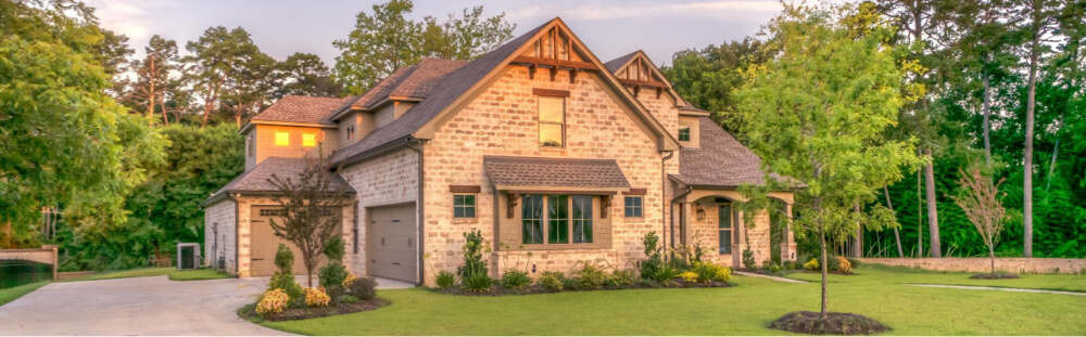 exterior of home with architectural asphalt roof after roof tuneup