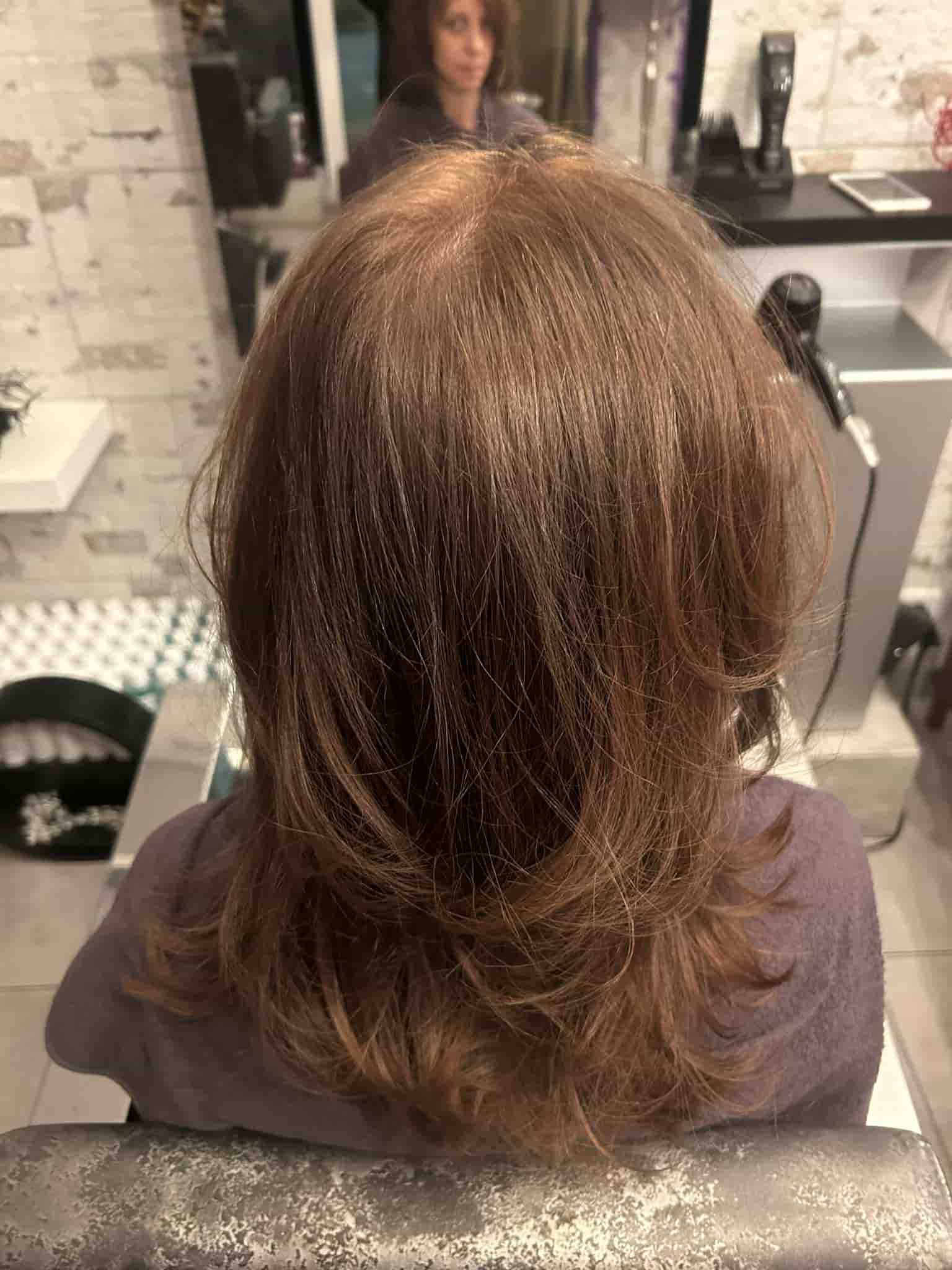 Photo of the back of a head with long, repaired, and healthy hair after QUEEN Keratin Therapy by KYANA.