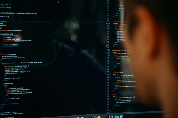 person looking at a computer screen with a programming code