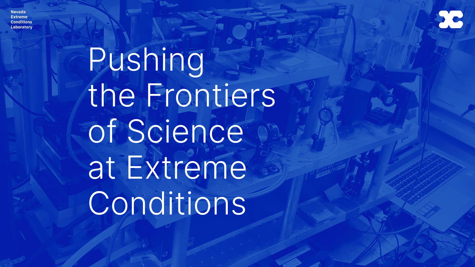 Pushing the Frontiers of Science at Extreme Conditions, overlayed over a vivid blue lab photo.