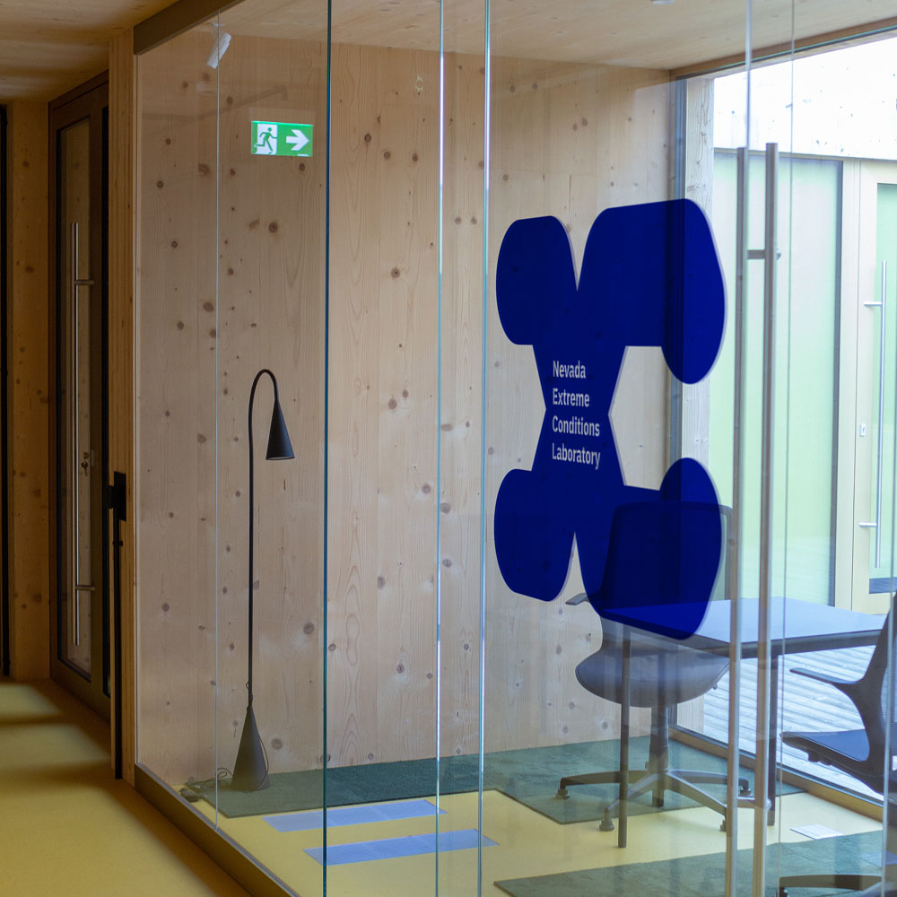 NEXCL logo on an office glass door