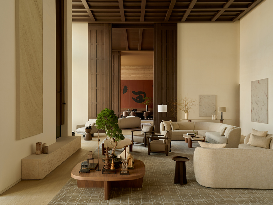 Modern living room with curved beige sofas, wooden coffee table, armchairs, and minimalist decor.