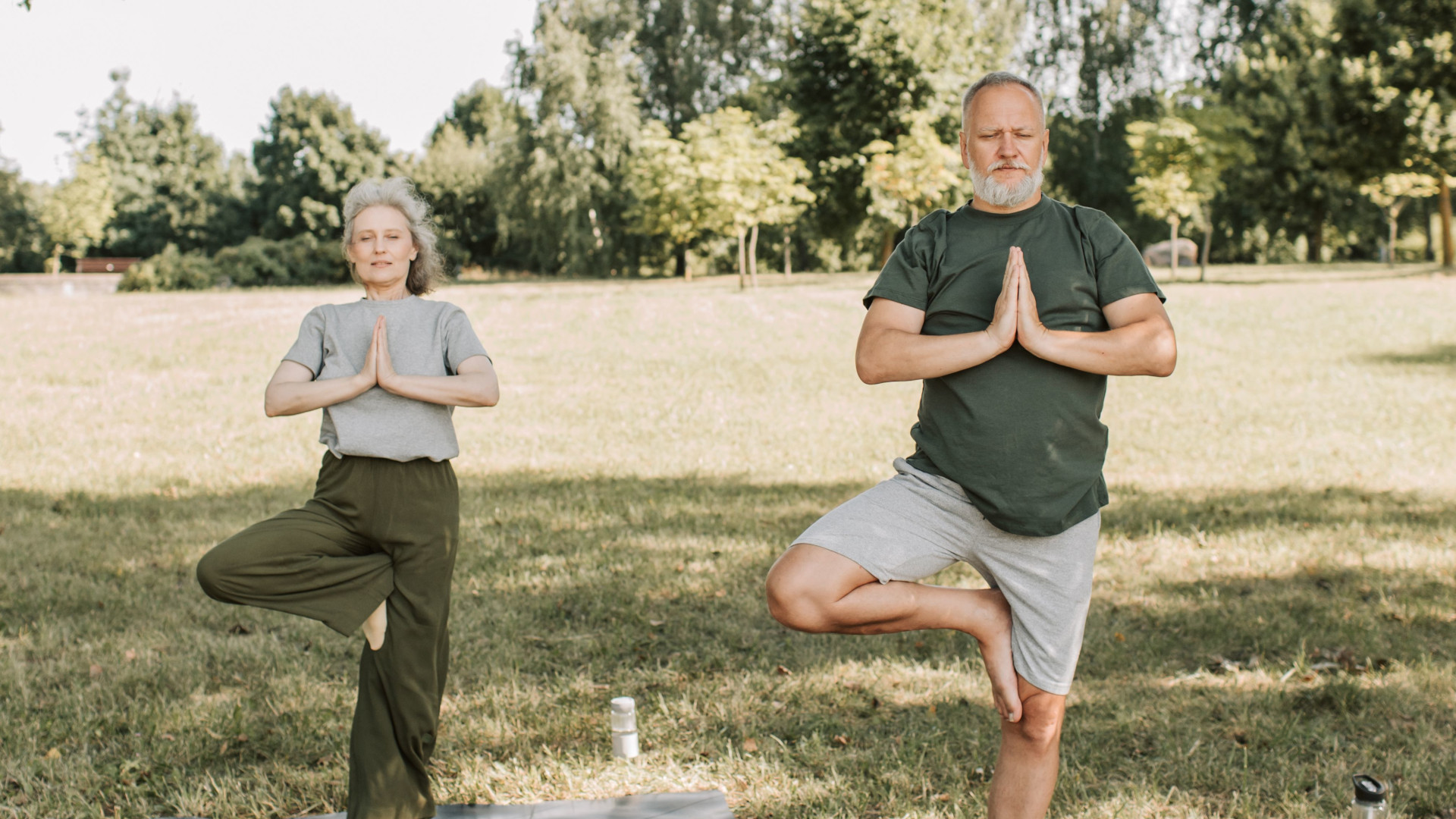 Two people balancing and having good posture in a park