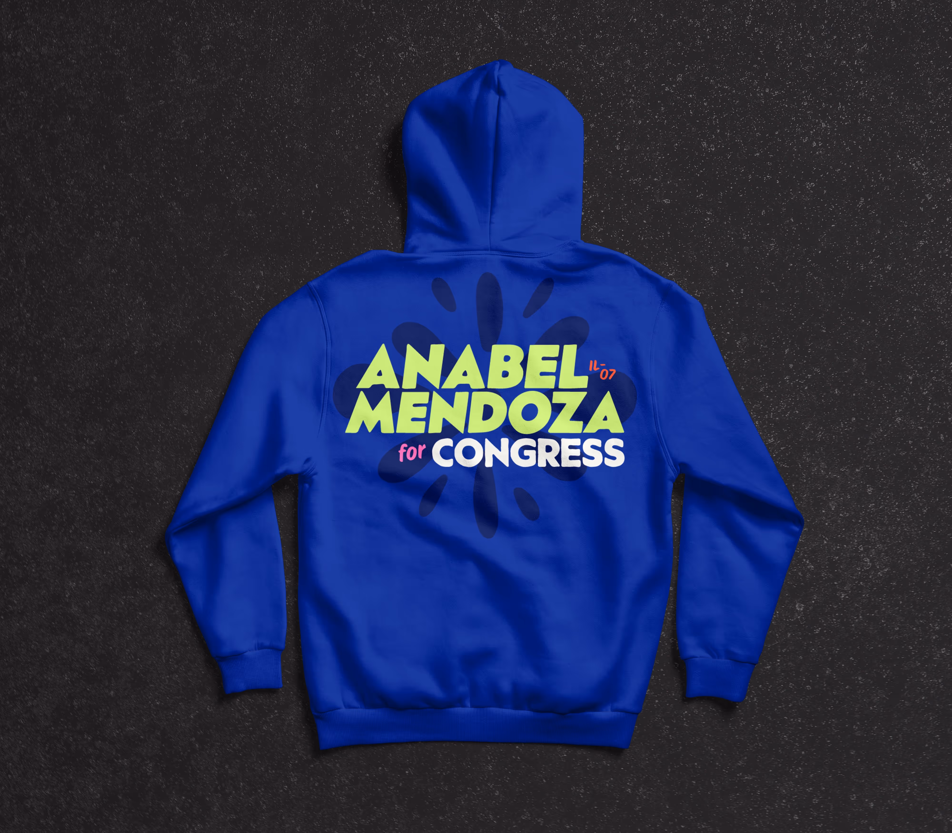 Back view of cobalt blue hoodie printed with deep blue papel picado flower medallion asset overlaid with the Anabel Mendoza for Congress IL-07 stacked logo in full color.