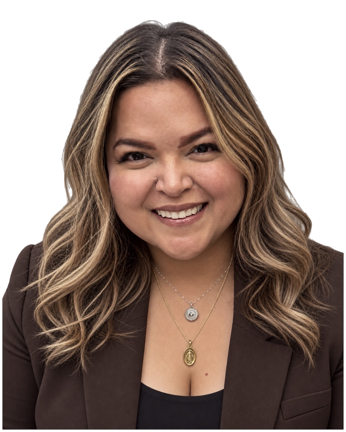 Smiling woman with wavy blonde and brown hair wearing a dark brown blazer and two necklaces with circular pendants on a white background.