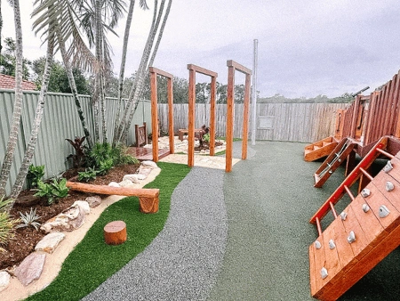 A play area with a climbing wall and a climbing frame.
