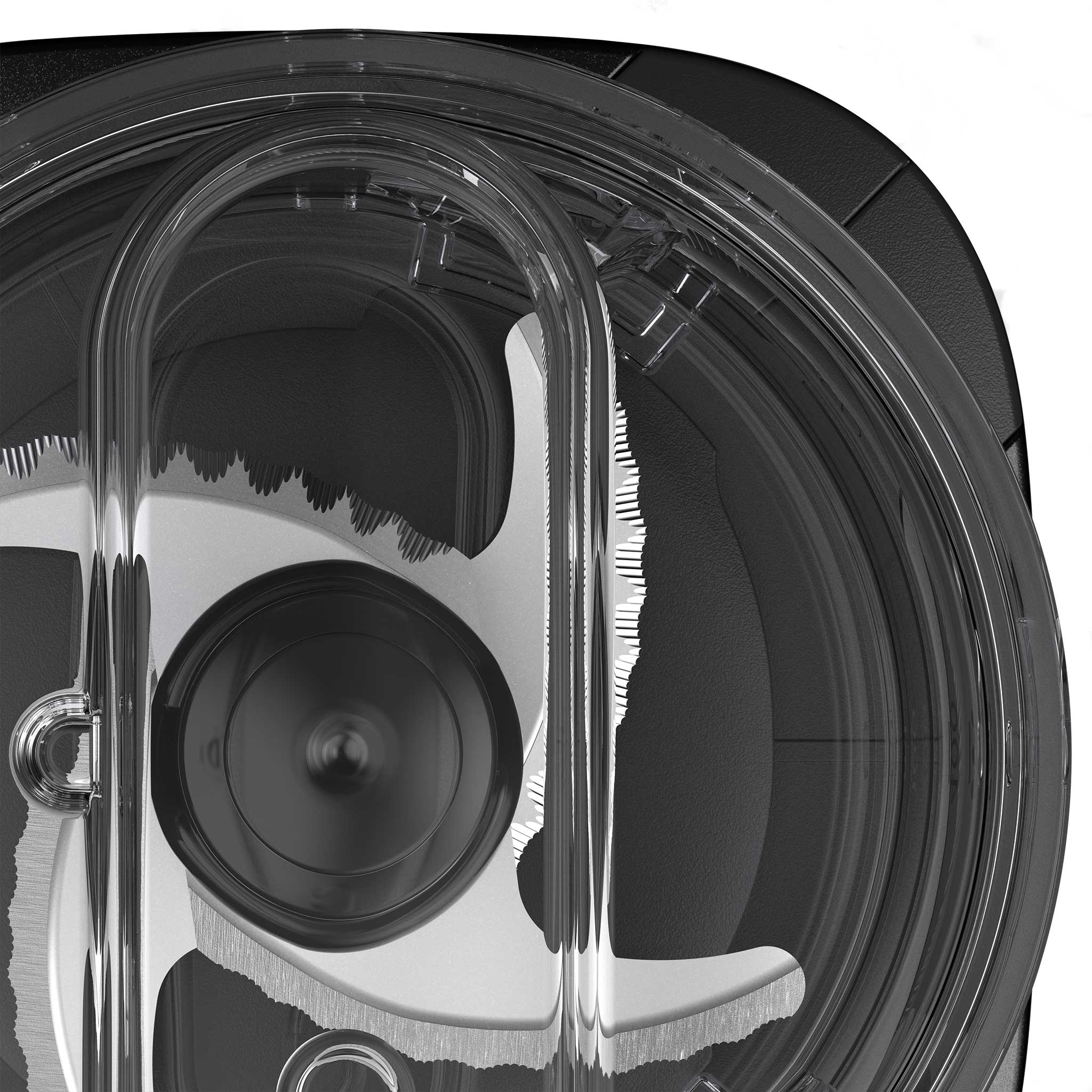 Close-up top view of the stainless steel rotating blade inside a transparent lid of a food chopper.