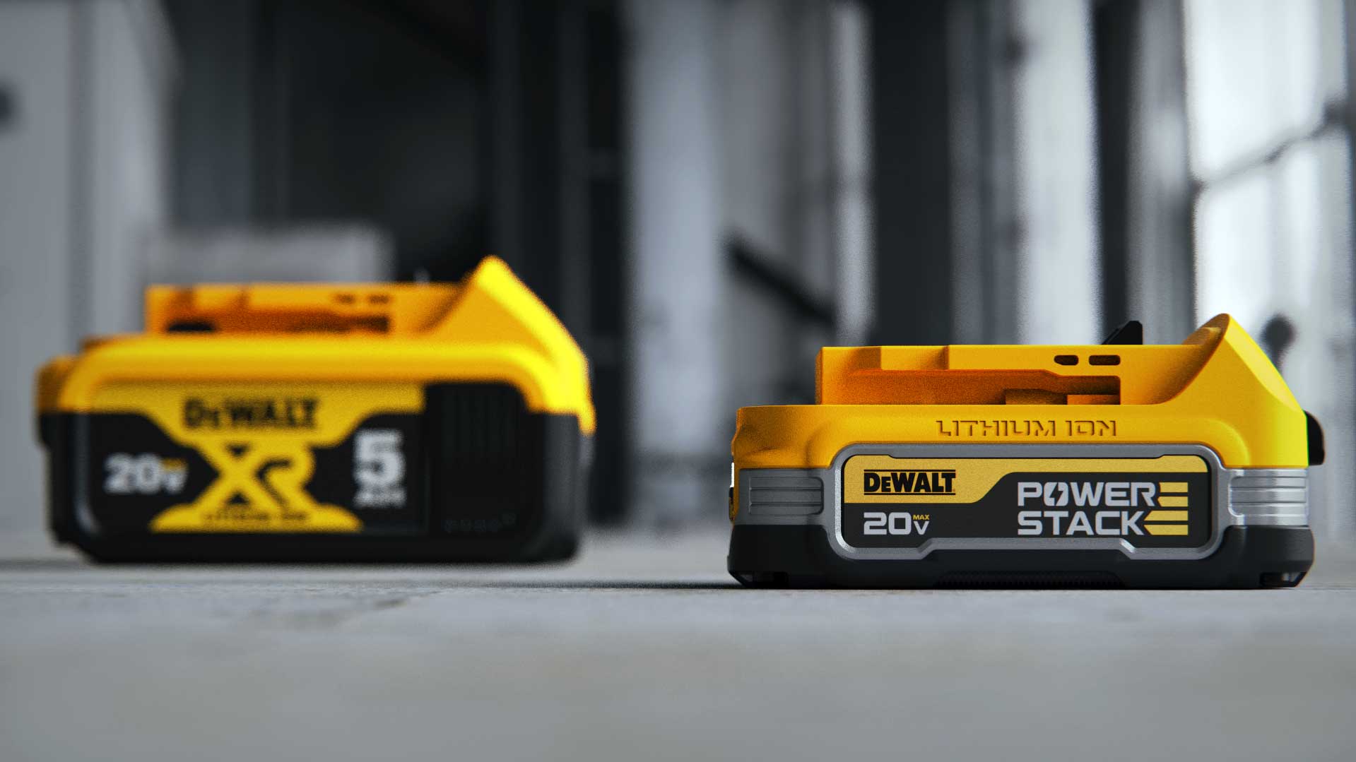 Two DeWalt 20V batteries on a gray surface, one close-up labeled Power Stack and one blurred in the background labeled XR and 5 Ah.