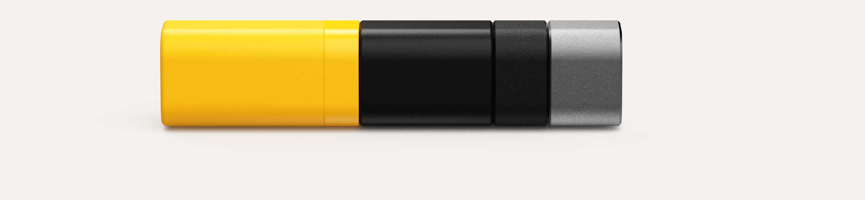 A lozenge shaped 3D colour swatch segmented into four parts with colours from left to right: yellow, matte black, textured black, and metallic grey.