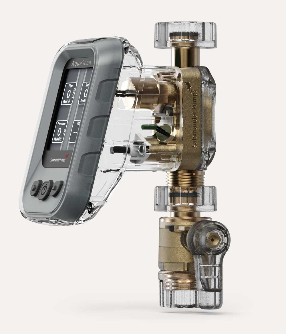 AquaScan device with a grey frame and display screen showing flow, temperature, and pressure readings, attached to transparent and brass plumbing components labelled Salamander Pumps.