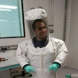 Portrait d'un homme en combinaison de protection blanche en laboratoire, Toufik Belbouab